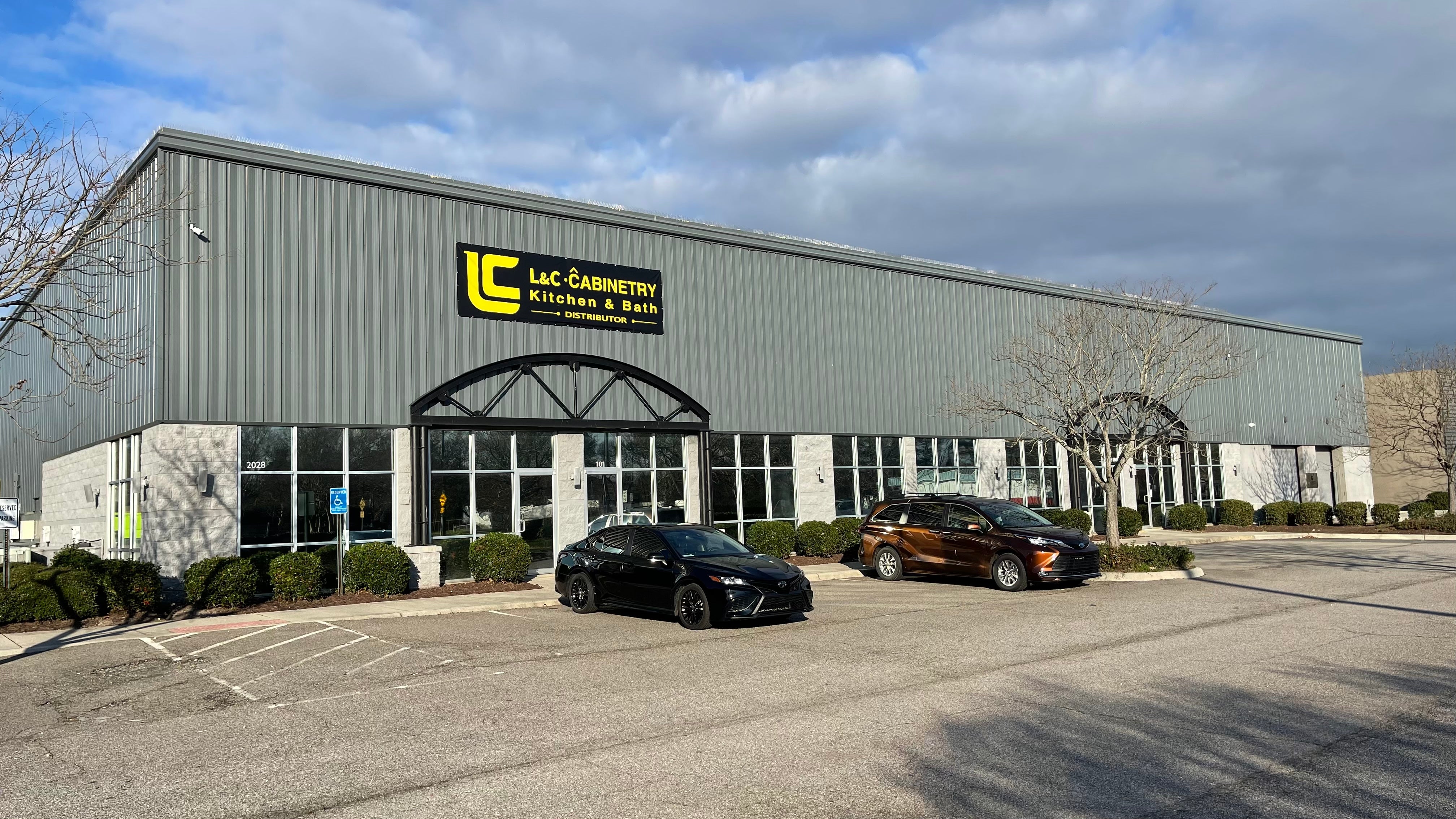 L&C Cabinetry warehouse exterior with cars parked, serving kitchen & bath distributors in VA