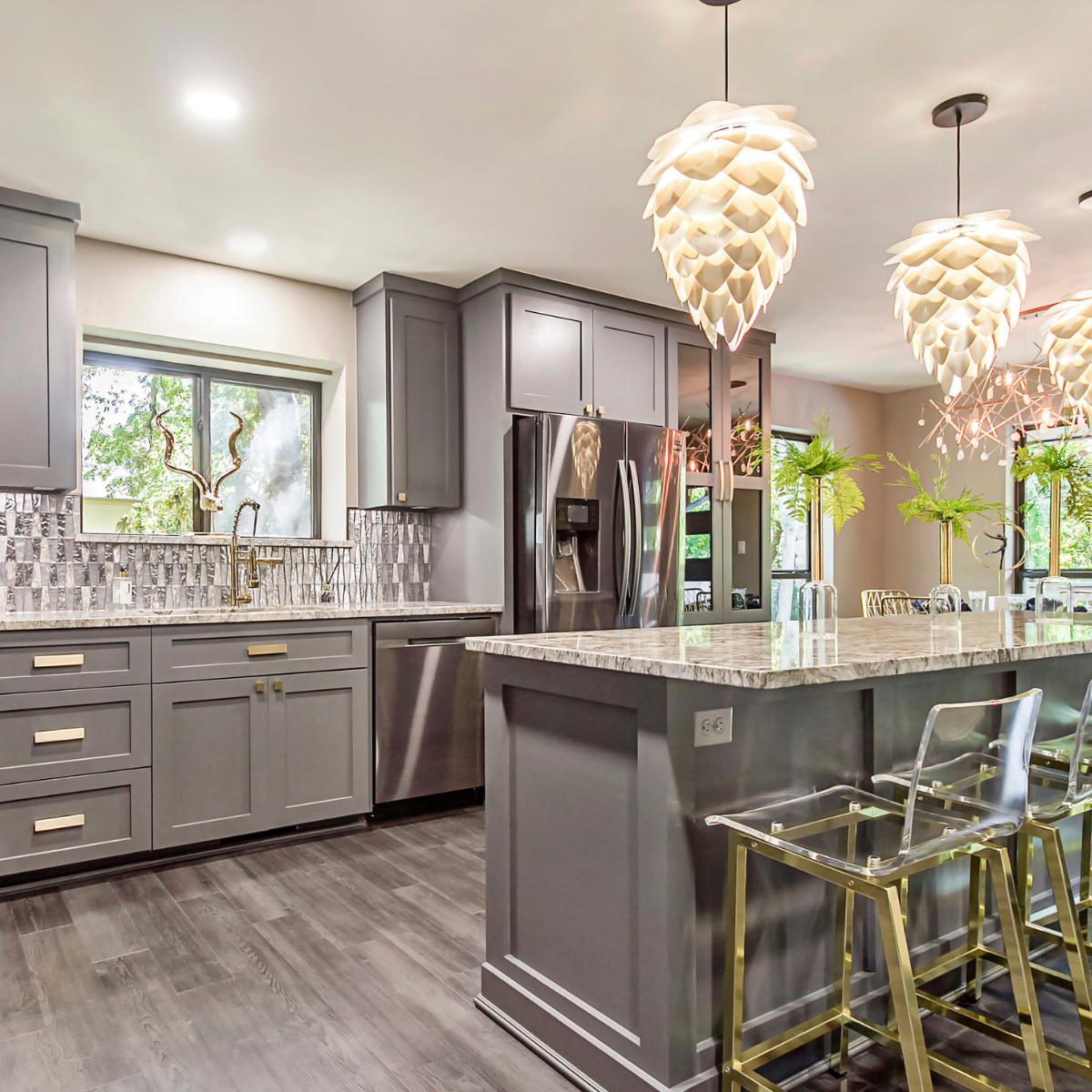 Modern gray kitchen cabinets with island, marble countertops, and pendant lighting for contractors and designers